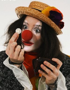 Clown holding coin --- Image by © Fancy/Veer/Corbis